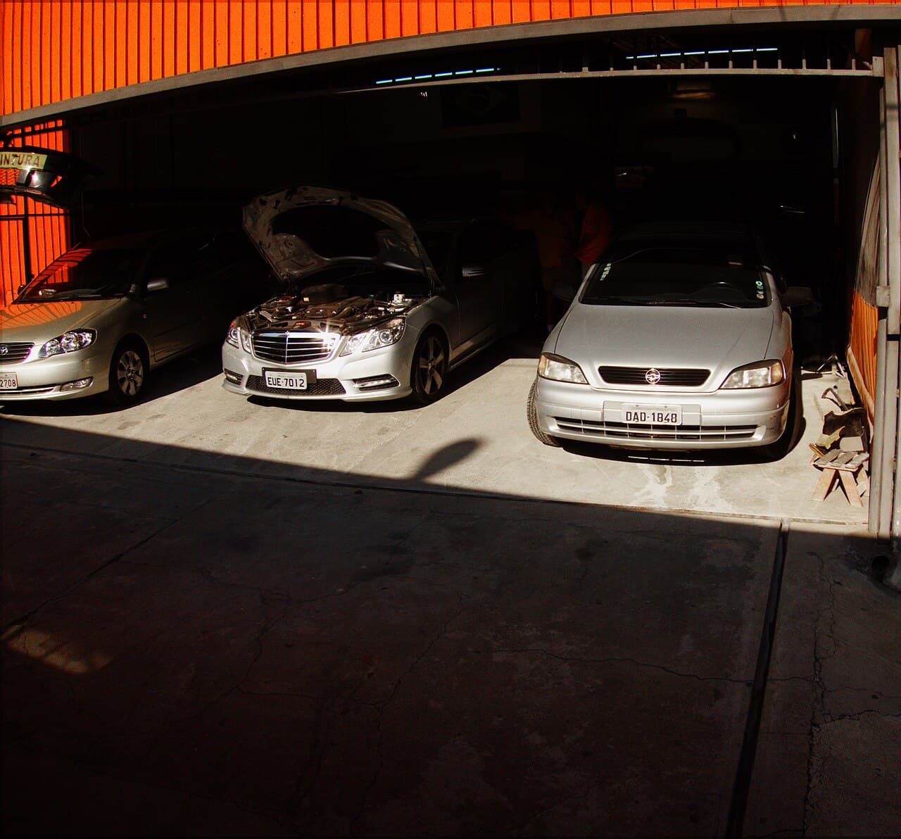Cars being serviced in a garage