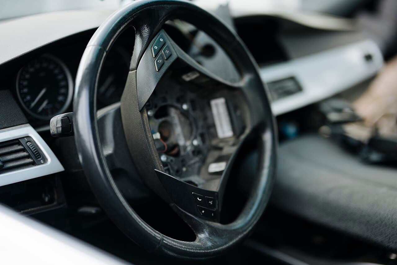 Car steering wheel and dashboard being repaired in a workshop